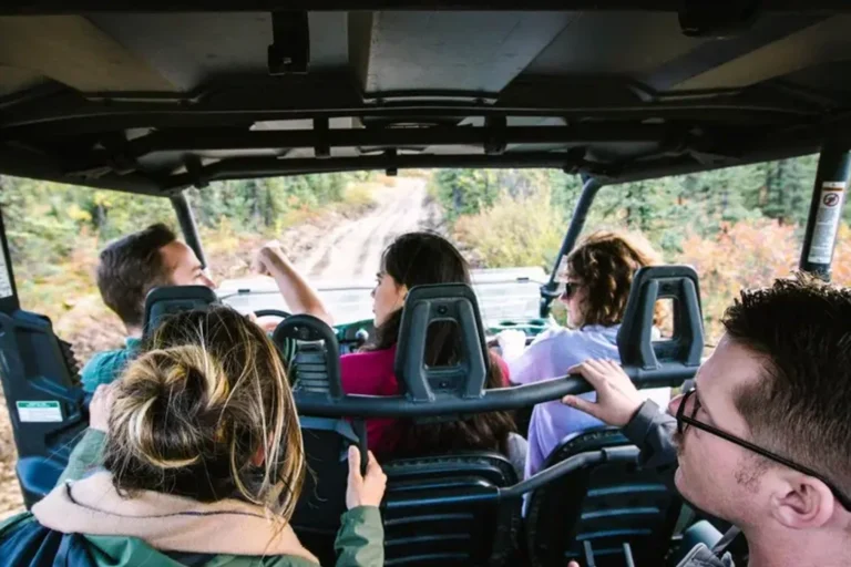 side by sdide atv tour guide and guests at chena